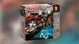 The Risk: 2210 A.D. board game box is shown at an angle, with sci-fi soldiers, futuristic vehicles and a glowing blue city on its illustrated front. Large red and black lettering reads “RISK 2210 A.D.” beside the Avalon Hill logo.
