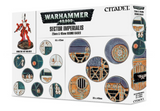 White Games Workshop box showing assorted circular sci-fi bases in teal, blue, cream and orange, with a red miniature pictured at left. The front reads “WARHAMMER 40,000,” “SECTOR IMPERIALIS” and “25MM & 40MM ROUND BASES”; side panels show more base designs.