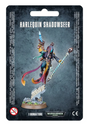 Front of a dark blue-gray blister card labeled “HARLEQUIN SHADOWSEER,” showing a colorful masked sci-fi miniature with a long striped staff, flowing ribbons and a rocky base. The bottom reads “1 MINIATURE” beside the Warhammer 40,000 logo.