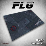 A rectangular gaming mat shown at an angle, printed with a dark gray sci-fi industrial floor plan, panel lines, and red markings. The graphic includes “FLG Mats,” “6x4’,” and “Sector 17.”