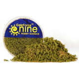 A mound of mottled green and brown Spring Undergrowth basing flock spills from a small round container with a blue-and-yellow label reading “GaleForce nine” and “HOBBY SCENICS.”