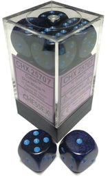 Dark blue and black speckled six-sided dice with bright blue pips are shown in a clear square display case, with two loose dice in front. The case label reads “CHX 25707” and “CHESSEX.”