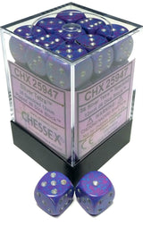 A clear square container holds many blue-purple speckled six-sided dice with silver pips; two matching dice sit in front. The label reads “CHESSEX” and “Silver Tetra.”