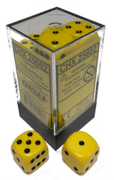 Opaque yellow six-sided dice with black pips are shown in a clear square case and as two loose dice in front. The yellow package label reads “CHX 25602” and “CHESSEX.”
