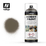Vallejo Hobby Paint primer aerosol can with a clear cap and white-and-black label, beside a sprayed dark olive-drab color swatch. The label reads “vallejo” and “HOBBY PAINT,” with the AV logo above.