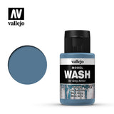 A blue-grey Model Wash paint bottle with a black cap and a label reading “vallejo,” “MODEL WASH,” and “Blue Grey,” shown beside a large circular blue-grey color swatch; the Vallejo logo appears above.