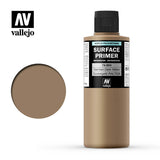 Vallejo Surface Primer bottle with a black cap and tan German Dark Yellow contents, shown beside a round matching color swatch. The label reads “SURFACE PRIMER” and “German Dark Yellow,” with the “vallejo” logo above.