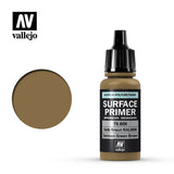 Vallejo Surface Primer bottle with a black ribbed cap and olive-brown label, beside a large matching brown-green color swatch. The label reads “SURFACE PRIMER” and “German Green Brown,” with the “vallejo” logo above.