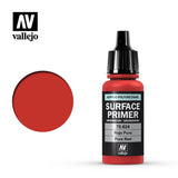 Red Vallejo primer bottle with a tall black ribbed dropper cap, shown beside a solid red circular swatch. The black label reads “SURFACE PRIMER” and “Pure Red,” with “vallejo” beneath the AV logo.