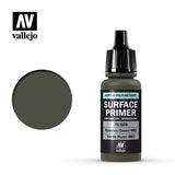 A small olive-green primer bottle with a tall black ribbed dropper cap stands beside a matching circular color swatch. Its black label reads “SURFACE PRIMER” and “Russian Green 4BO,” with the Vallejo logo above.