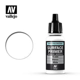 White Vallejo Surface Primer bottle with a tall black dropper cap and black label, shown beside a white circular swatch outlined in black. The label reads “SURFACE PRIMER,” “70.600” and “White,” with the Vallejo logo.