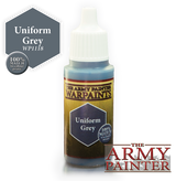 An upright Warpaint bottle with a white ribbed cap, blue-gray neck and gold label reading “THE ARMY PAINTER WARPAINTS” and “Uniform Grey.” A gray hexagon callout reads “Uniform Grey WP1118,” beside a “100% MATCH to colour primer” badge and large Army Painter logo.