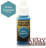 An upright paint bottle with a white ribbed cap, turquoise paint visible at the neck and base, and a black-and-gold label. The turquoise hexagon reads “Hydra Turquoise”; a matching swatch marked “Hydra Turquoise WP141” appears at upper left, with “THE ARMY PAINTER” at lower right.