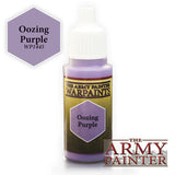 A purple paint bottle with a white dropper cap and a dark label reading “THE ARMY PAINTER WARPAINTS” and “Oozing Purple.” A purple hexagonal swatch beside it reads “Oozing Purple” and “WP1445,” with “THE ARMY PAINTER” logo at lower right.