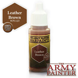 A small brown paint bottle with a white dropper cap and a brown-and-gold label reading “THE ARMY PAINTER WARPAINTS” and “Leather Brown.” A brown color swatch graphic and “THE ARMY PAINTER” logo appear beside it on a white background.