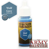 A small paint bottle with a white dropper cap, blue neck and base, and a yellow-and-dark label reading “THE ARMY PAINTER WARPAINTS” and “Wolf Grey.” A matching blue “Wolf Grey” color swatch appears beside the bottle, with The Army Painter logo at the lower right.