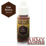 Small brown paint bottle with a tall white ribbed cap and a yellow-and-brown label reading “THE ARMY PAINTER WARPAINTS” and “Oak Brown.” A dark brown hexagon beside it reads “Oak Brown” and “WPI124,” with a large “THE ARMY PAINTER” logo at lower right.