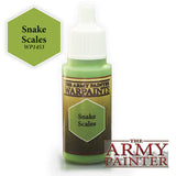Small paint bottle with a white pointed cap and green paint visible at the neck and base, featuring a dark gold label with a green hexagon marked “Snake Scales” and “WARPAINTS.” A matching green hexagon marked “Snake Scales WP1453” and the “THE ARMY PAINTER” logo appear beside it.