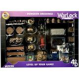 A boxed Warlock Tiles dungeon dressing set with assorted miniature terrain pieces visible through a clear window, including barrels, chests, crates, furniture and stone details. Purple packaging reads “DUNGEON DRESSINGS,” “WarLock,” and “LEVEL UP YOUR GAME!”